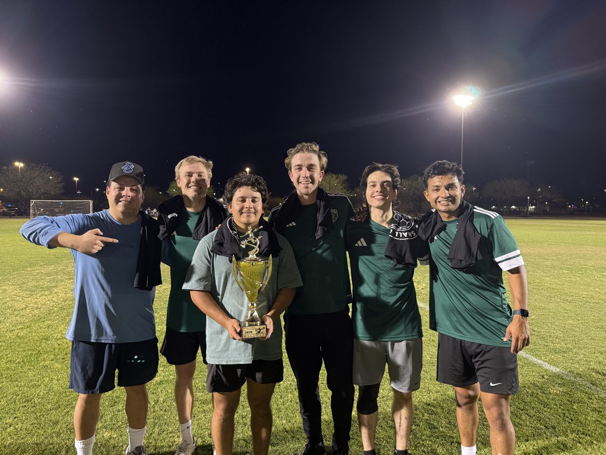Erick and his soccer team with a league trophy